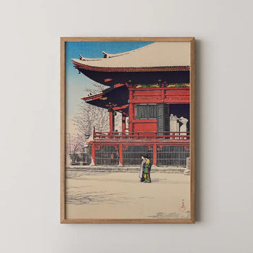 Hasui Kawase woodblock print of Asakusa Kannon Temple after snow, a red temple hall under a clear sky with two women walking the snowy grounds.
