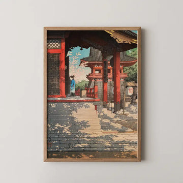 Hasui Kawase woodblock print of Fudo Temple in Meguro, a red pavilion and hanging bell framed by a dark timber gateway with a woman at the railing.