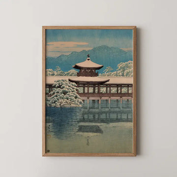 Hasui Kawase woodblock print of Heianjingu Shrine, a covered bridge and pavilion reflected in a still pond with snow dusted pines and distant mountains.