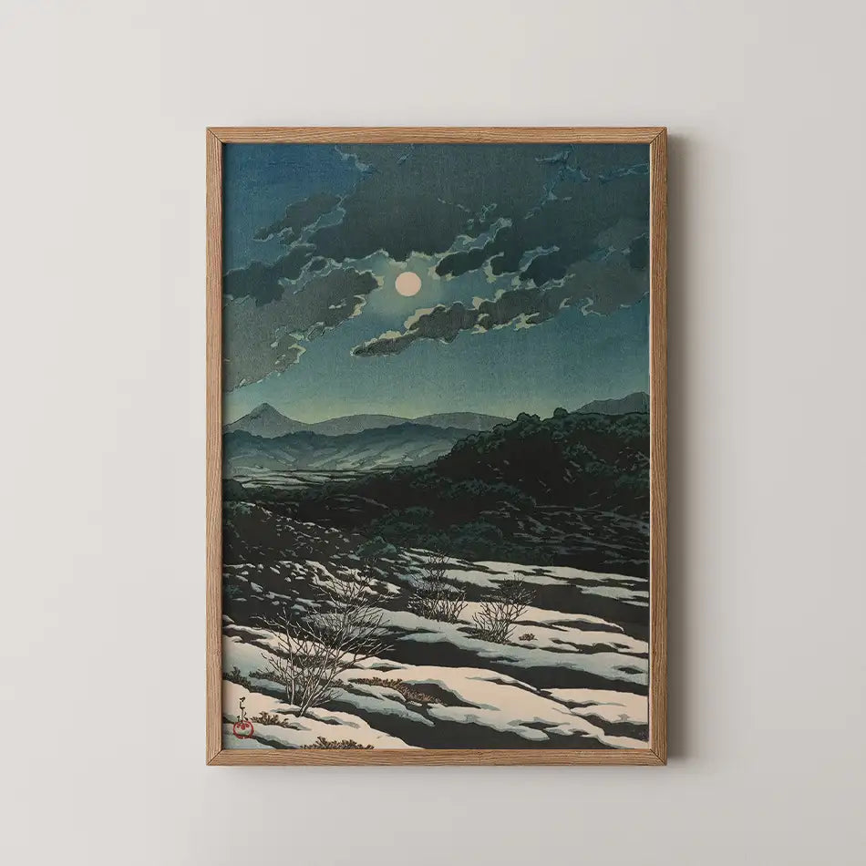 Hasui Kawase woodblock print of Karikachi Mountain Pass at night, a full moon behind clouds above snow patched dark hills.