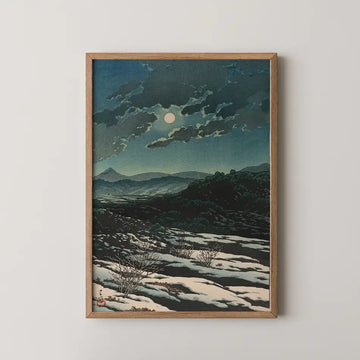 Hasui Kawase woodblock print of Karikachi Mountain Pass at night, a full moon behind clouds above snow patched dark hills.
