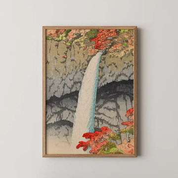 Hasui Kawase woodblock print of Kegon Waterfall at Nikko, a white waterfall dropping through a striped cliff framed by red autumn maple.