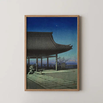 Hasui Kawase woodblock print of Kozu, Osaka, a temple pavilion's roof silhouetted against city lights and a star at dusk.