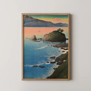 Hasui Kawase woodblock print of Kude Beach in Wakasa, a rocky headland with a pine tree and a sailboat on a sunset sea.