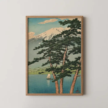 Hasui Kawase woodblock print of Lake Kawaguchi, Mount Fuji framed by tall pine trunks with a small sailboat on the calm water.