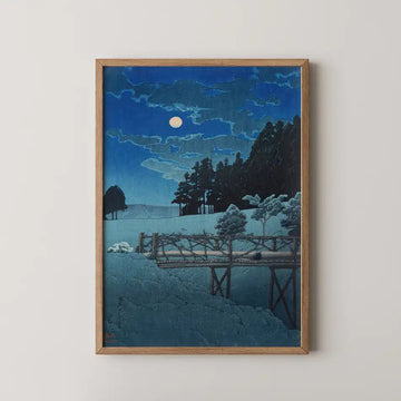 Hasui Kawase woodblock print of Moon over Akebi Bridge, a plain wooden bridge crossing a snow covered field under a bright full moon.