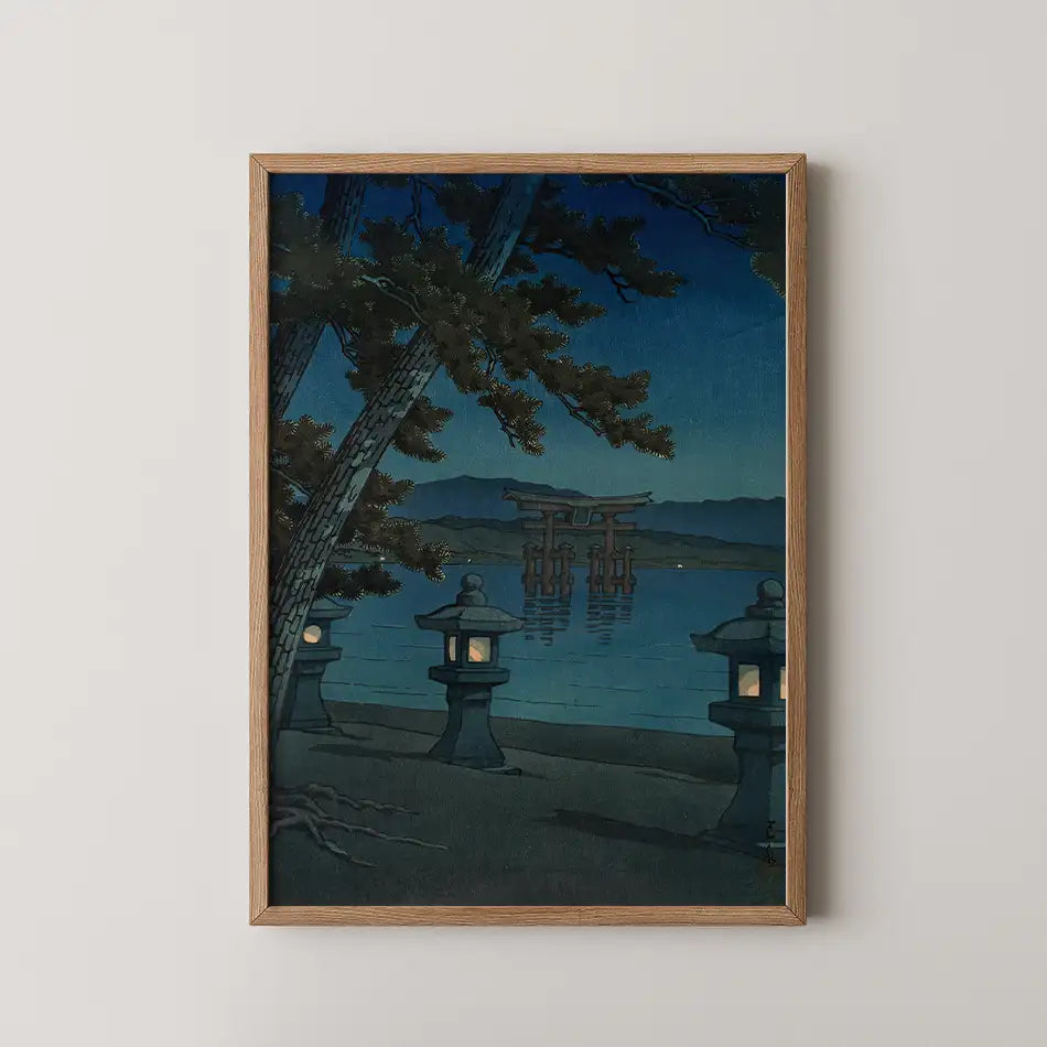 Hasui Kawase woodblock print of Moonlit Night at Miyajima, the floating torii gate seen through pine branches with lit stone lanterns on the shore.