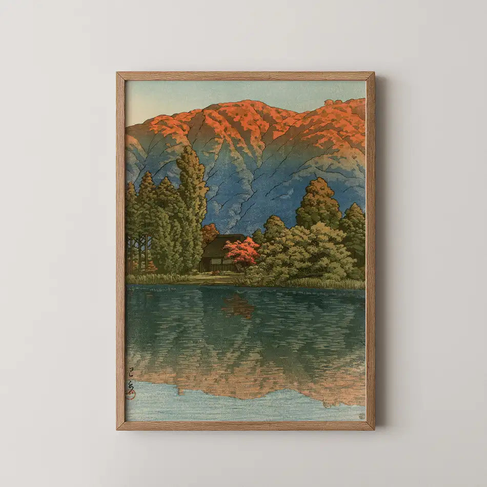 Hasui Kawase woodblock print of Morning at Ao Marsh, Ura Heights, an autumn mountain ridge in red and gold reflected in still water.