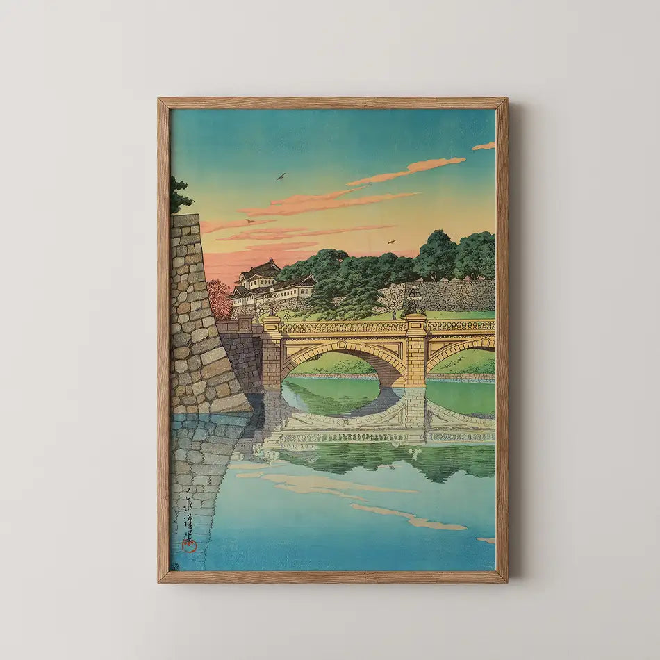 Hasui Kawase woodblock print of Nijubashi bridge at the Tokyo Imperial Palace at dawn, stone arches reflected in the moat under a pink and gold sky.