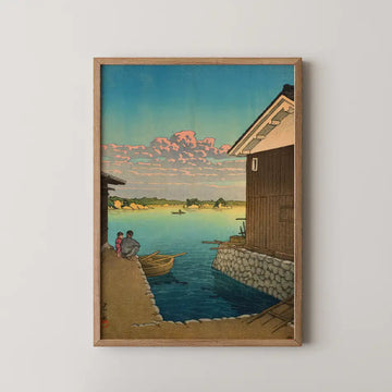 Hasui Kawase woodblock print of Morning in Yobuko, Hizen, a fishing harbour at dawn with pink clouds reflected on calm water.