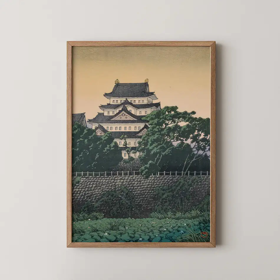 Hasui Kawase woodblock print of Nagoya Castle, its tiered white keep and dark roofs rising above green trees at dusk.