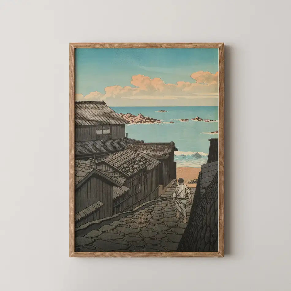 Hasui Kawase woodblock print of Namikiri in Shima, a stone lane between fishing houses leading down to a bright blue sea.