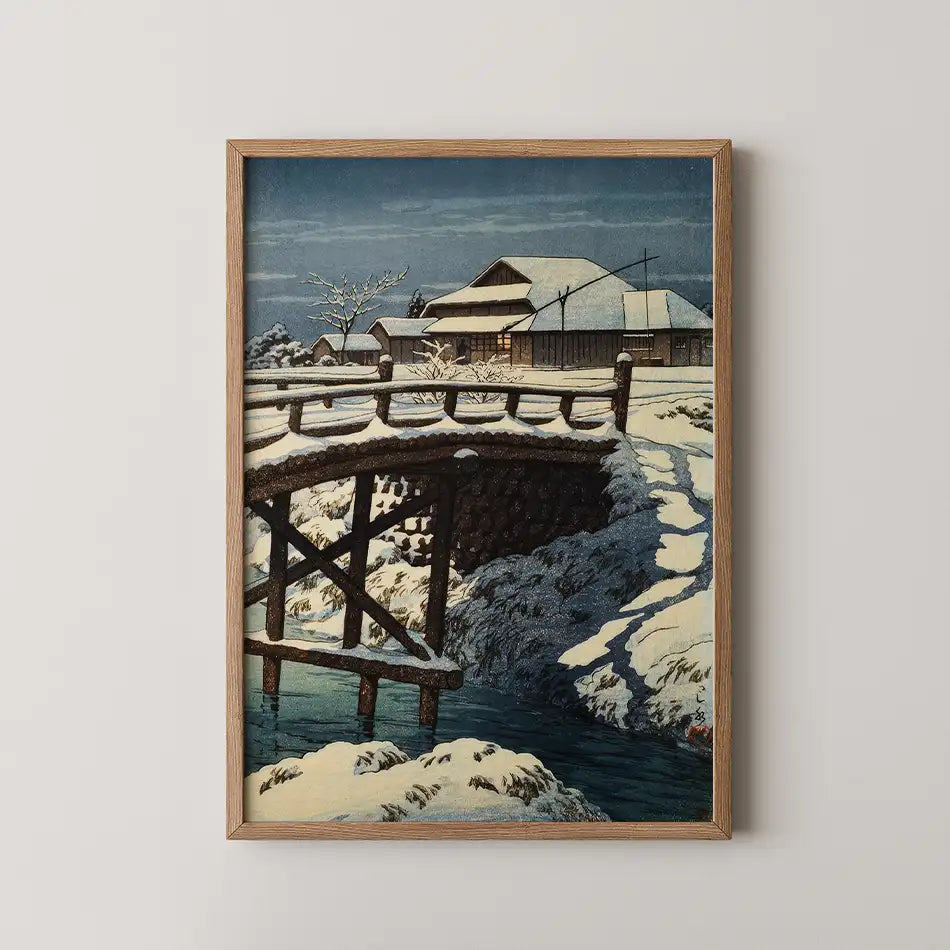 Hasui Kawase woodblock print of Ono in Mito, a snow covered wooden bridge over a dark stream on a still winter night.