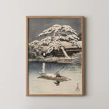 Hasui Kawase woodblock print of Snow at Funabori, a snow laden pine over a canal as a boatman poles home past a lit window at night.