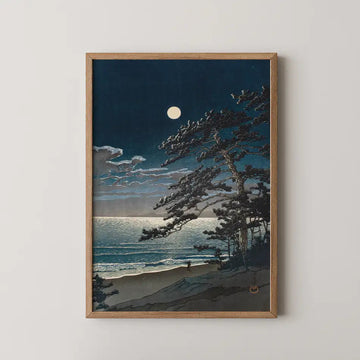 Hasui Kawase woodblock print of Spring Moon at Ninomiya Beach, a wind bent pine leaning over the shore as the full moon rises over the sea.