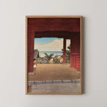Hasui Kawase woodblock print of Tamonji Temple at Hamahagi, a child standing beneath a large red gate framing a coastal village and sea.