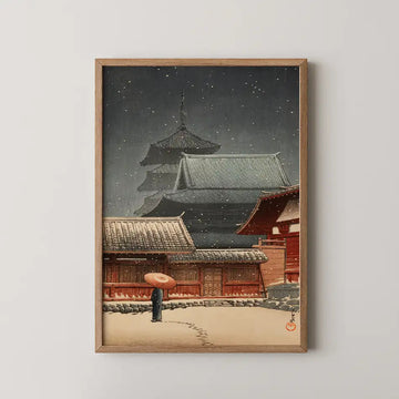 Hasui Kawase woodblock print of Tennoji Temple in Osaka at night, snow falling over a five story pagoda while a figure crosses the courtyard under a red umbrella.