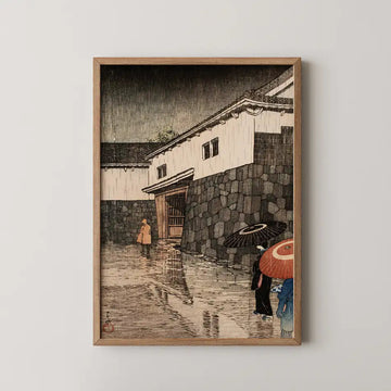 Hasui Kawase woodblock print of Uchiyamashita, Okayama, figures with umbrellas passing a stone gate in heavy night rain.