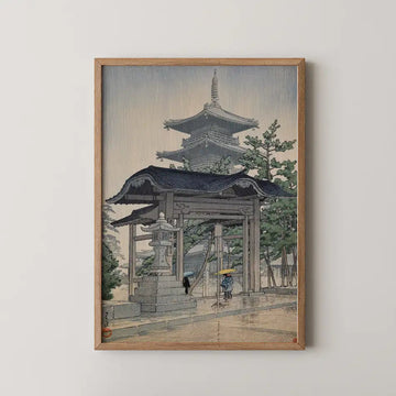 Hasui Kawase woodblock print of Zentsuji Temple in Sanuki, a thatched gate and distant pagoda seen through falling rain with two figures under umbrellas.