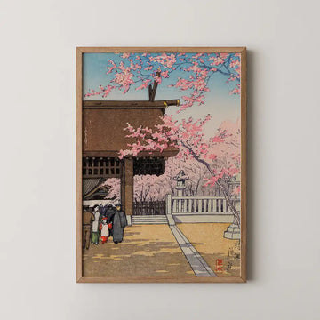 Hasui Kawase woodblock print of Yasukuni Shrine, visitors passing beneath a wooden gate under heavy pink cherry blossom.