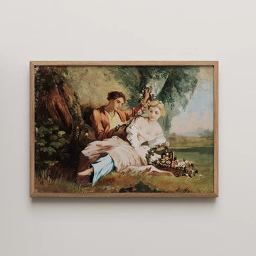 Painting of a man and woman seated in a natural setting, with the man adorned with flowers and the woman wearing a white dress, framed in a wooden frame.