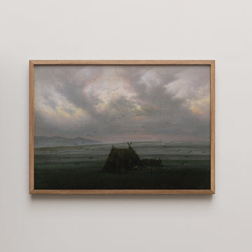 Landscape painting featuring a silhouette of a thatched hut against a moody sky filled with clouds and flying birds, framed in natural wood.