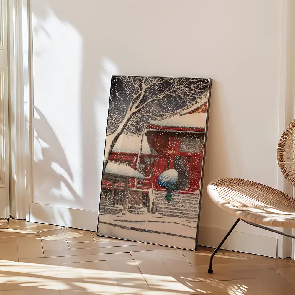 A serene winter landscape painting featuring a traditional building, snow-covered trees, and a figure holding a blue umbrella, displayed against a light wall with sunlight casting shadows.