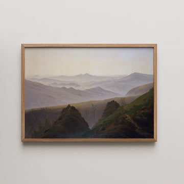 Framed painting of rolling green hills and mountains under a soft pastel sky.