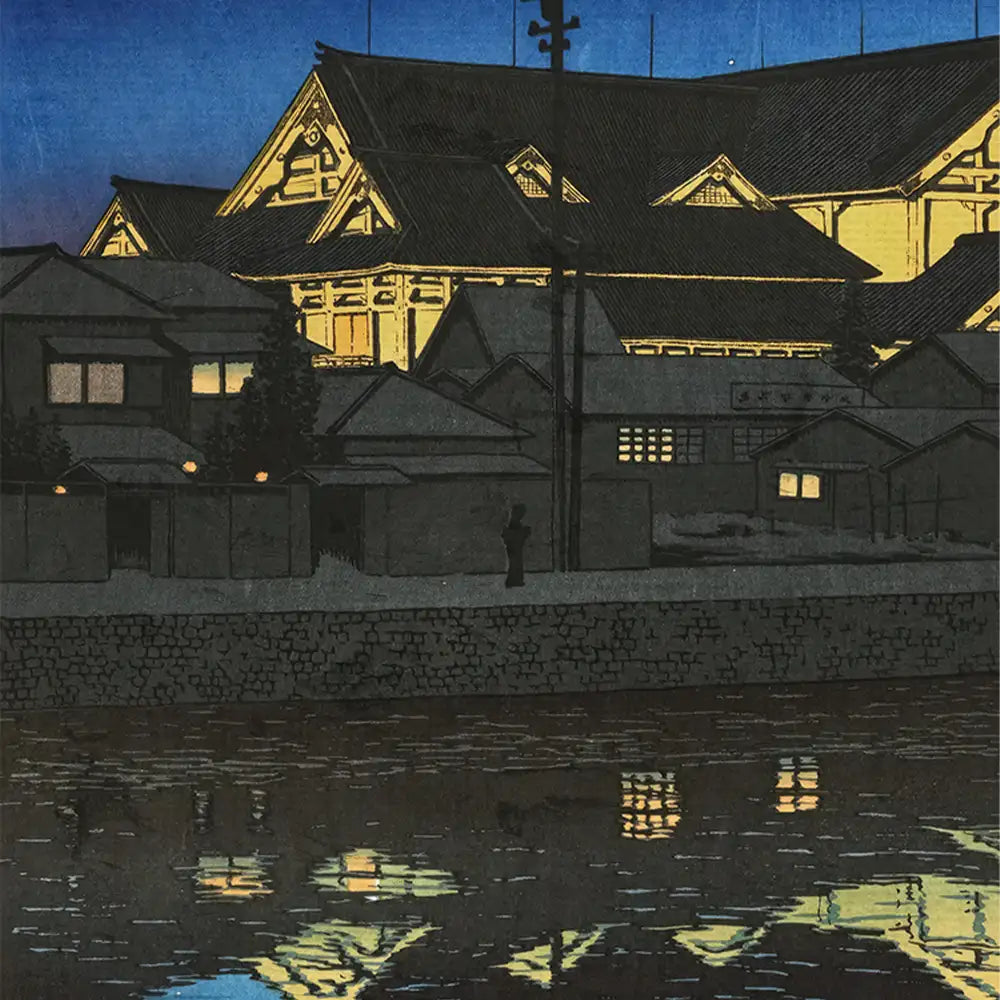 A serene night scene depicting traditional Japanese buildings illuminated against a dark blue sky, reflecting on the water below.