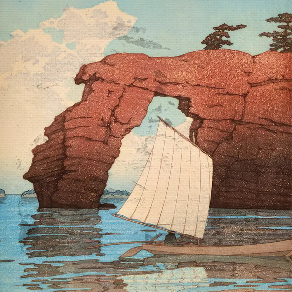 Sailboat navigating through an arch rock formation with a serene blue sky and calm water reflections.