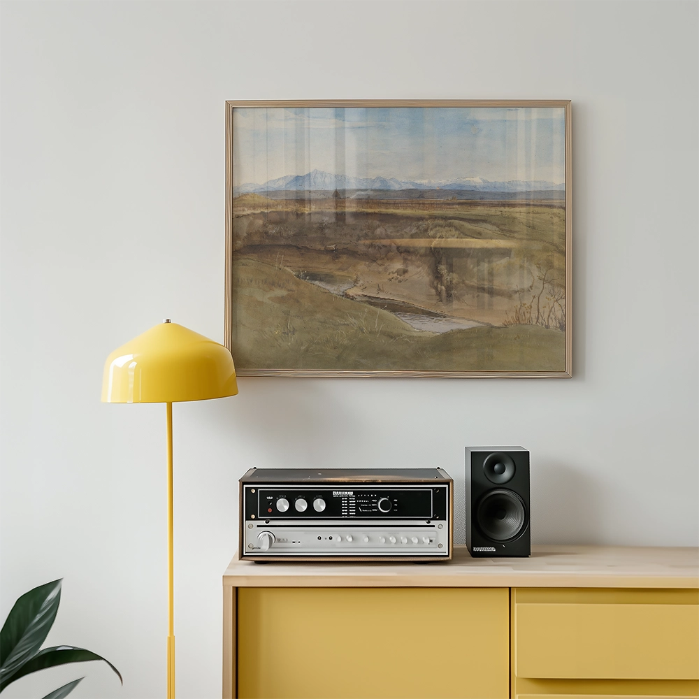 Framed landscape painting above a yellow lamp and vintage audio equipment on a wooden cabinet.