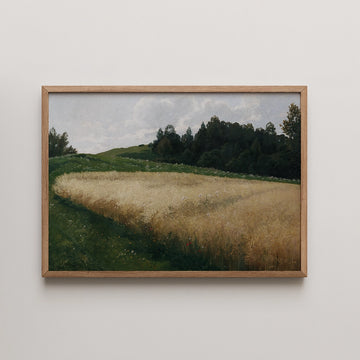 Framed painting of a scenic landscape featuring golden fields, green hills, and a cloudy sky.