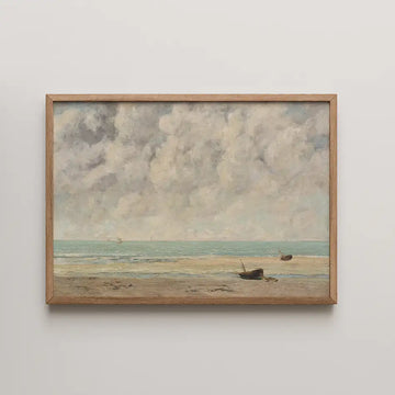 Framed painting of a serene beach scene with boats on the shore and a cloudy sky.