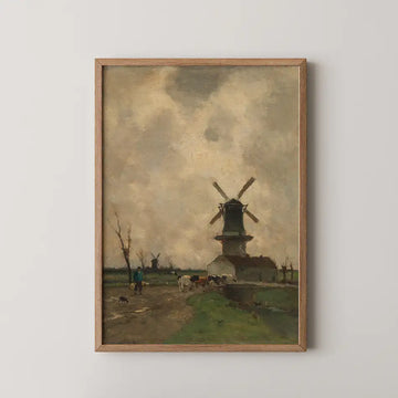 Framed painting of a countryside scene featuring a windmill, cows, and people walking on a dirt path under a cloudy sky.