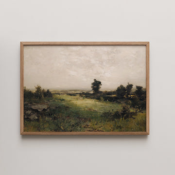 Framed landscape painting featuring a serene green field under a cloudy sky with distant trees.