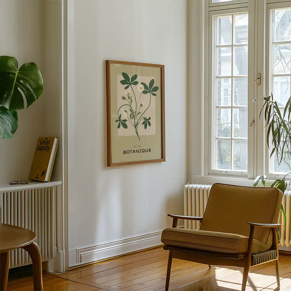 Modern botanical poster print framed in a minimalist living room setting with natural light, featuring green plants and a vintage book.