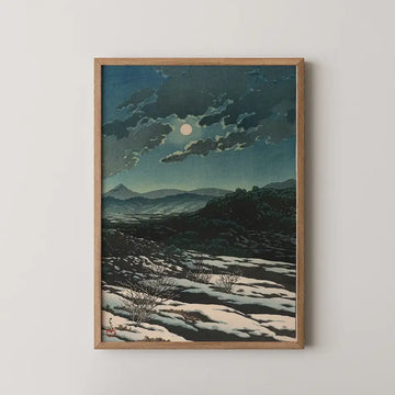 Framed painting of a moonlit landscape with clouds and mountains in the background