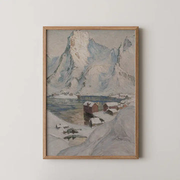 Framed painting of a snowy mountain landscape with a calm lake and small wooden houses.