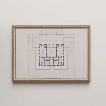 Framed architectural floor plan artwork on a white wall
