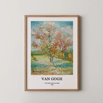 Framed painting of "The Pink Peach Tree" (1888) by Van Gogh, showcasing a blooming tree in vibrant colors against a serene landscape.