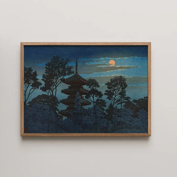Framed painting of a pagoda surrounded by trees under a moonlit sky.