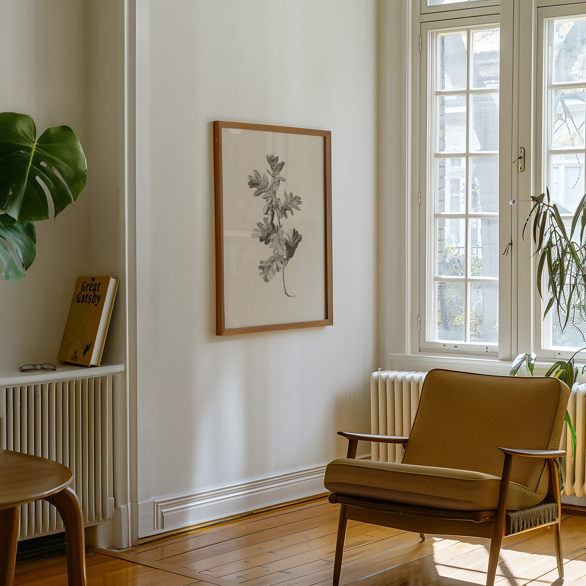 A botanical print framed in wood hanging on a wall in a cozy interior with a chair and a plant.