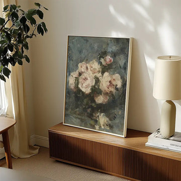 Painting of a floral arrangement featuring soft pink roses, displayed in a modern interior setting with natural light and a wooden console.