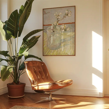 A cozy living space featuring a modern brown chair, a large green plant, and a colorful floral painting on the wall.