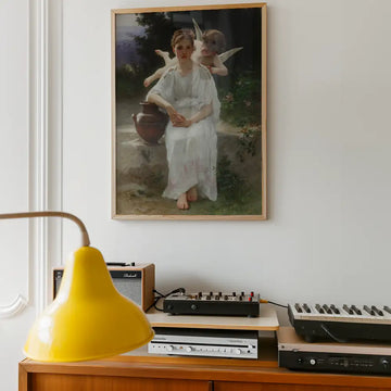 Painting of a woman in a white dress sitting beside a pot, accompanied by two winged cherubs, displayed on a wall above a vintage record player and a yellow lamp.