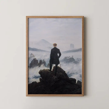 Framed painting of a solitary figure standing on a rocky outcrop, gazing over a misty landscape with distant mountains and a cloudy sky.