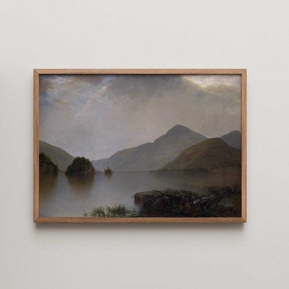 Framed landscape painting of mountains reflecting in a calm lake under a cloudy sky
