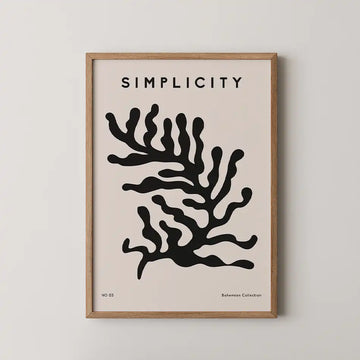 Minimalist art print featuring a black silhouette of seaweed on a blush pink background, framed in natural wood, from the Bohemian Collection.