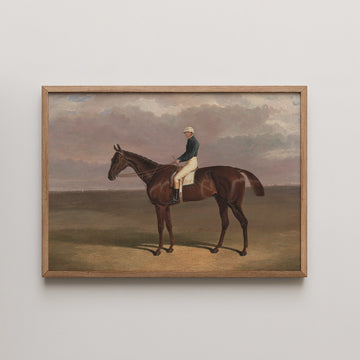 Framed painting of a horse rider in a landscape, featuring a brown horse and a rider in traditional attire against a cloudy sky.