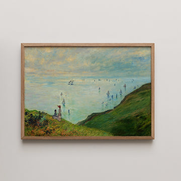 Framed painting of a serene landscape featuring two figures on a cliff overlooking a bay filled with sailboats under a cloudy sky.